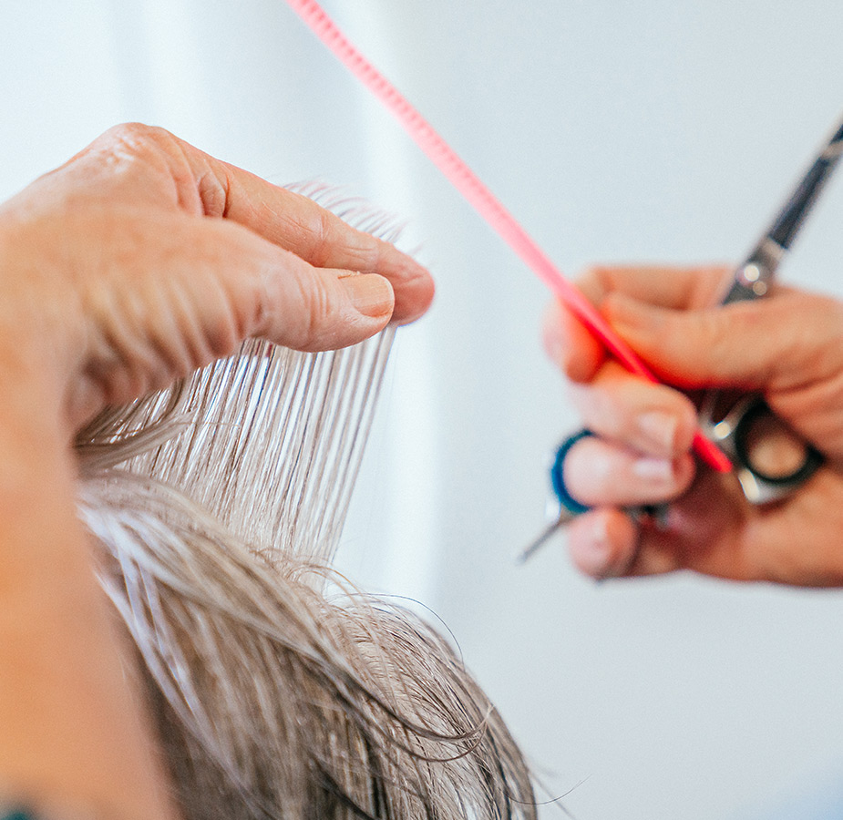 A resident is having their haircut.