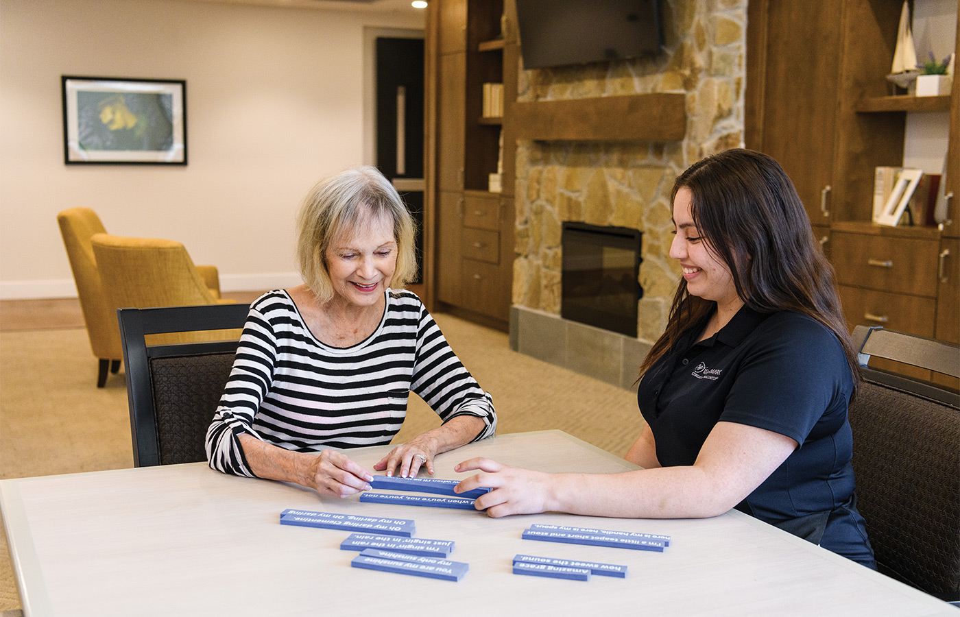 A person helping another with word blocks.