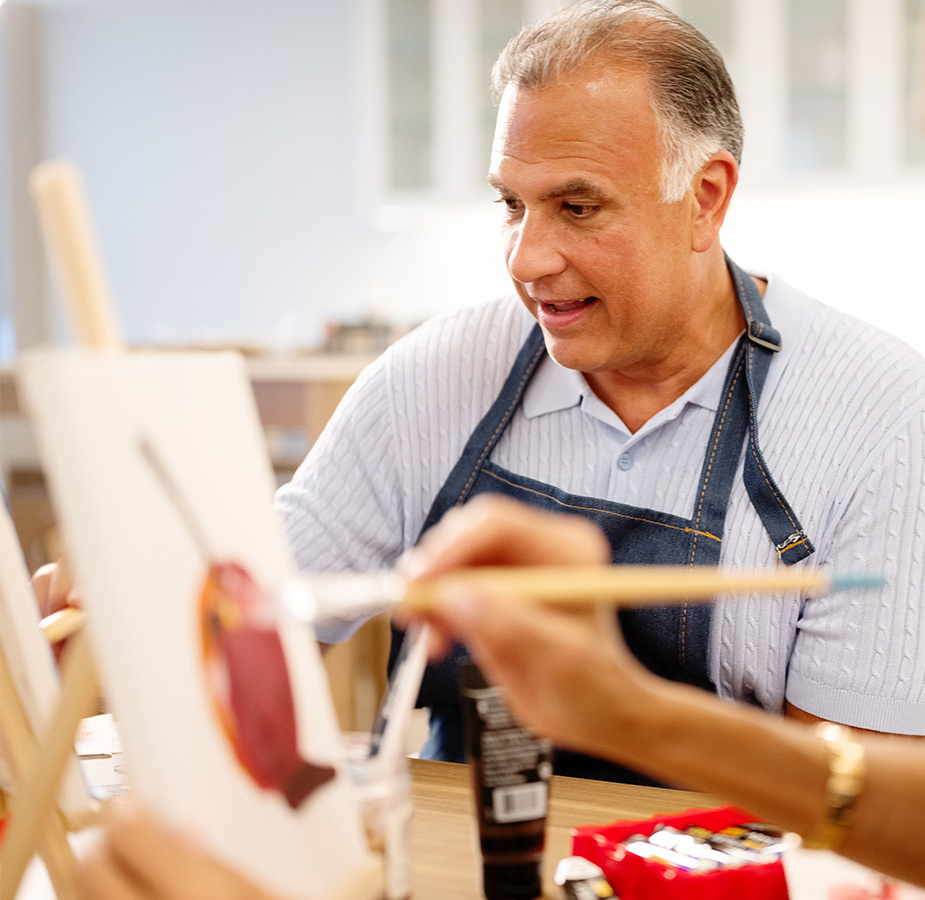 A person painting in a class.