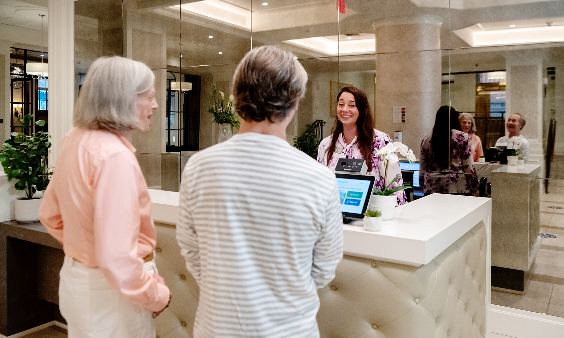 Residents are talking to an associate at the front desk.