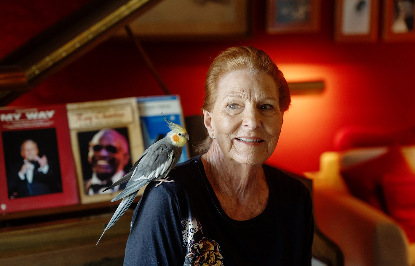 A person with a bird on their shoulder.