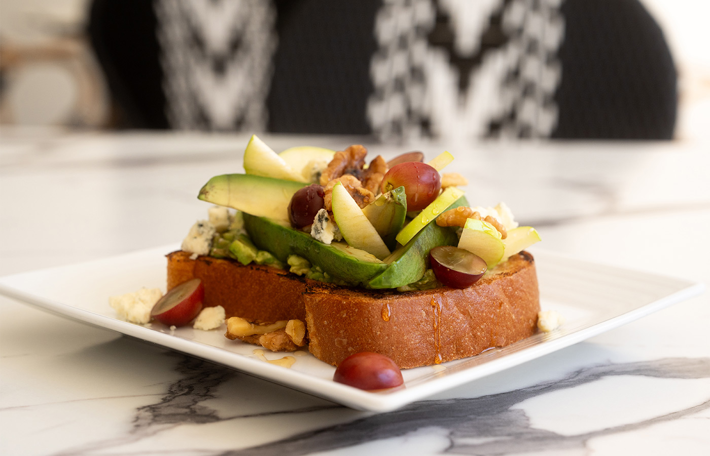A plate with avocado toast on it.