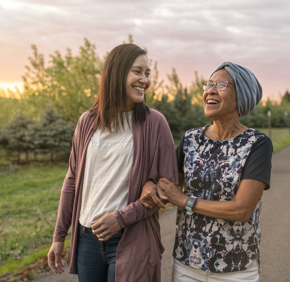 Two people are walking at sunset.