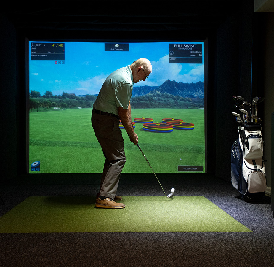 A person using a golf simulator.