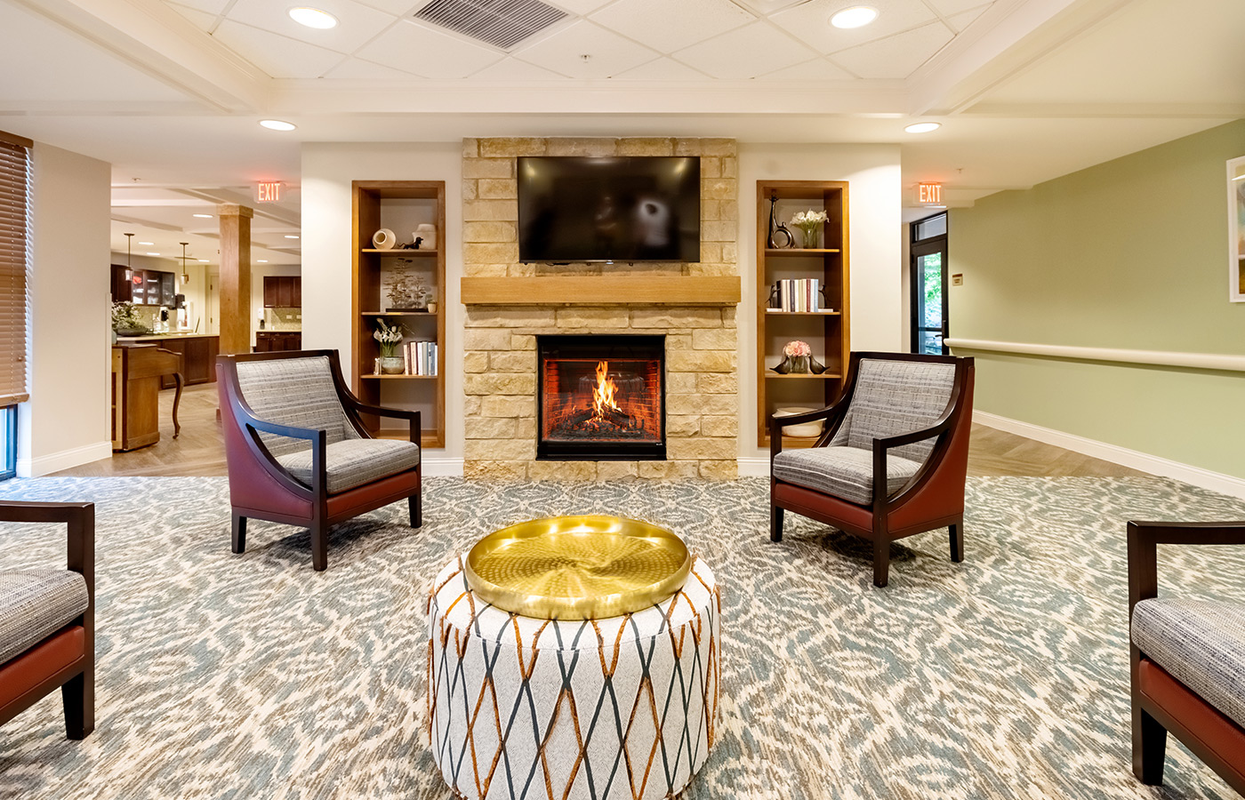 A lounge with seating and a fireplace.