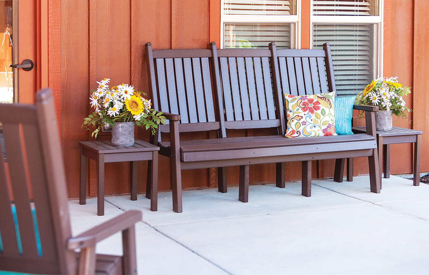 Brown bench with flowers.