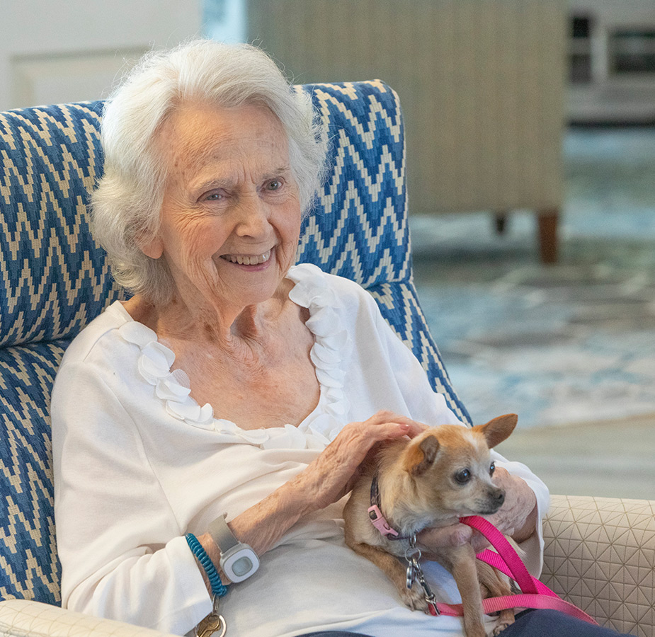 Resident holding a dog.