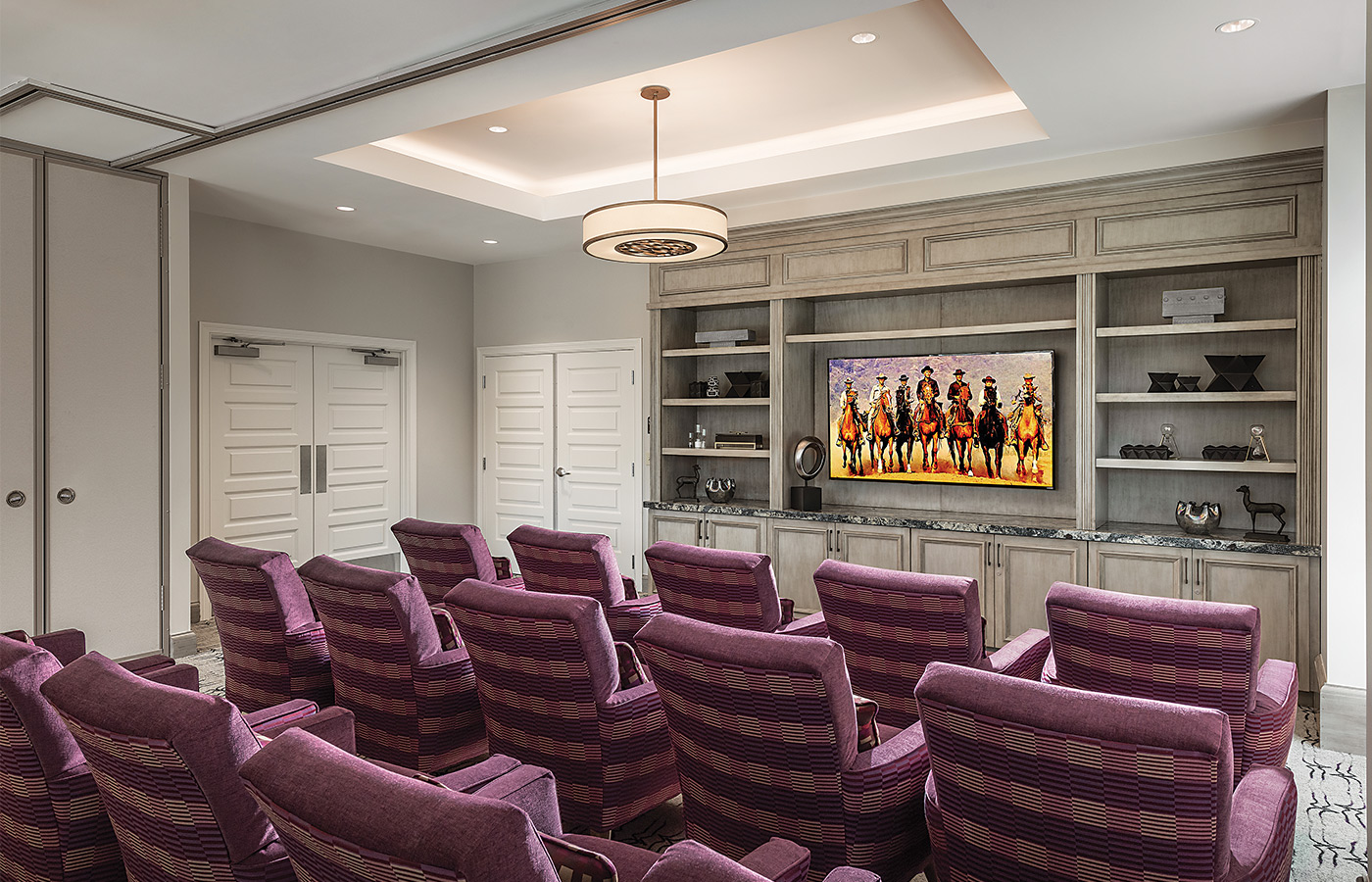 Row of chairs facing television in media room.