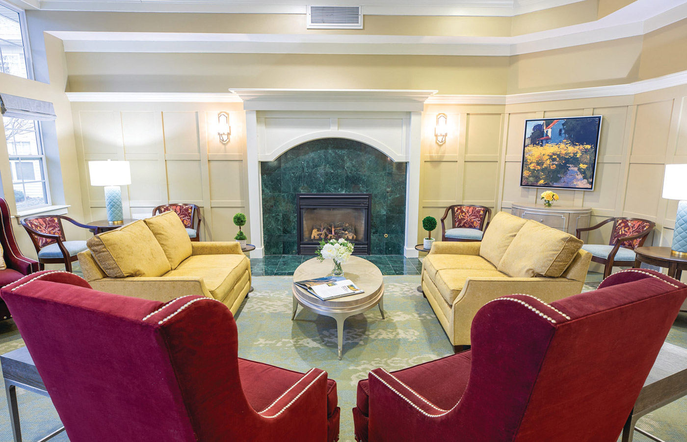 A seating area in front of a fire place at The Legacy at Park Crescent.
