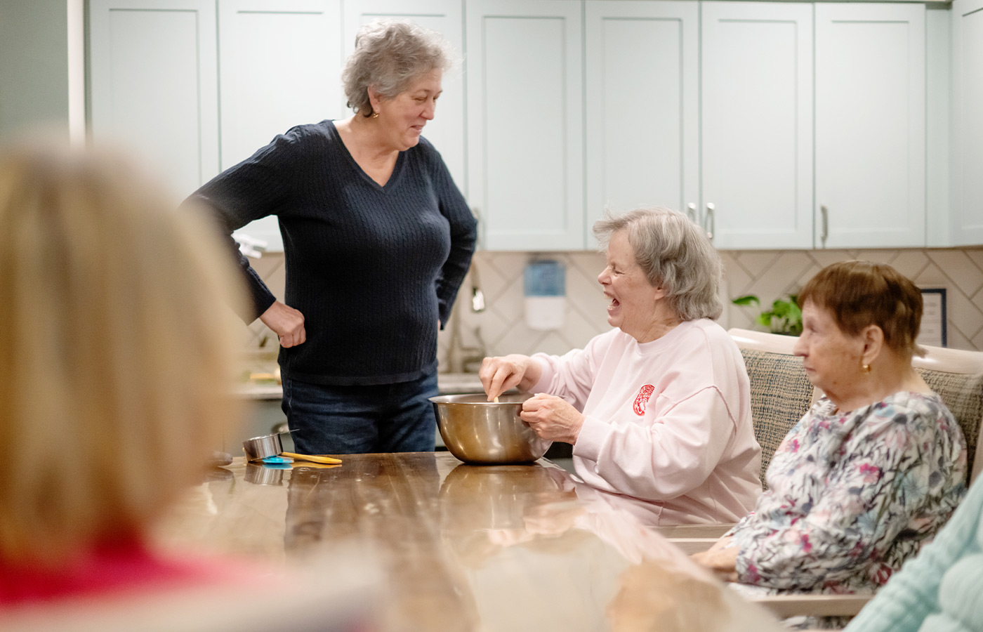 A group of people at a table getting ready to bake.