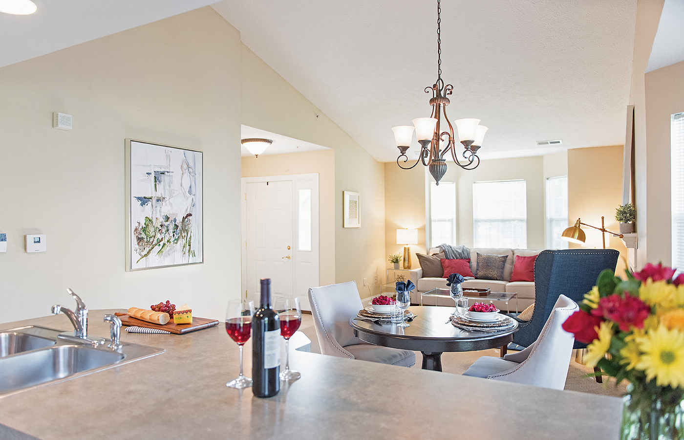 Furnished living room space with sofa, table, and seating area.