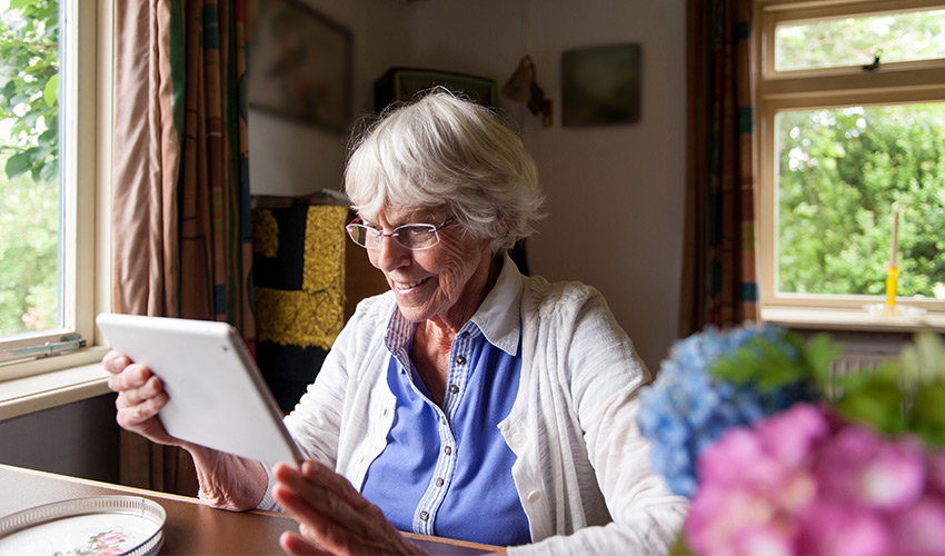 video-call-850x500 A senior woman looking at her ipad.