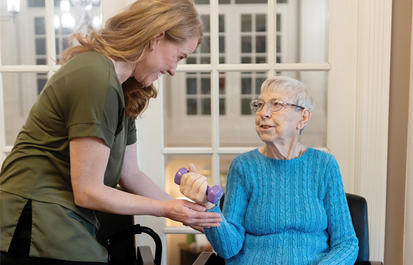 A resident working with a physical therapist.