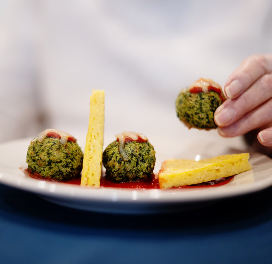A hand picking up a bite of food.