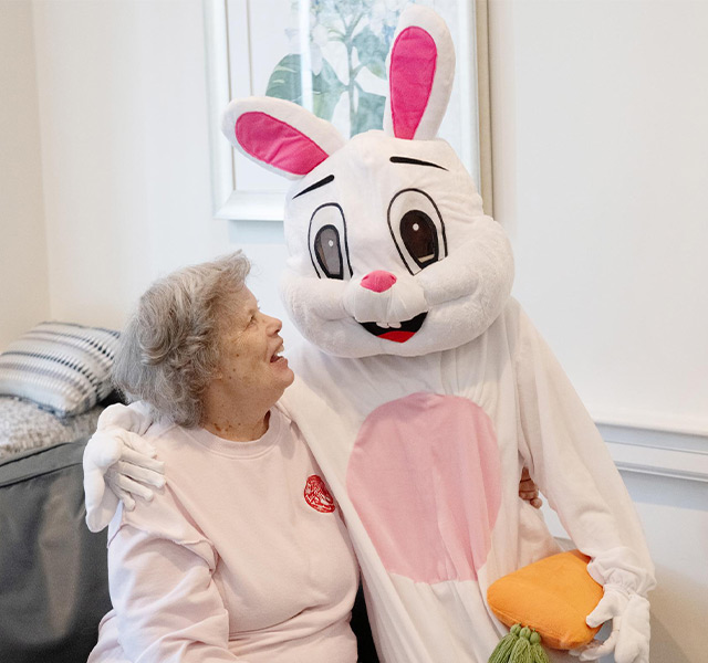 A large bunny sitting with a person.
