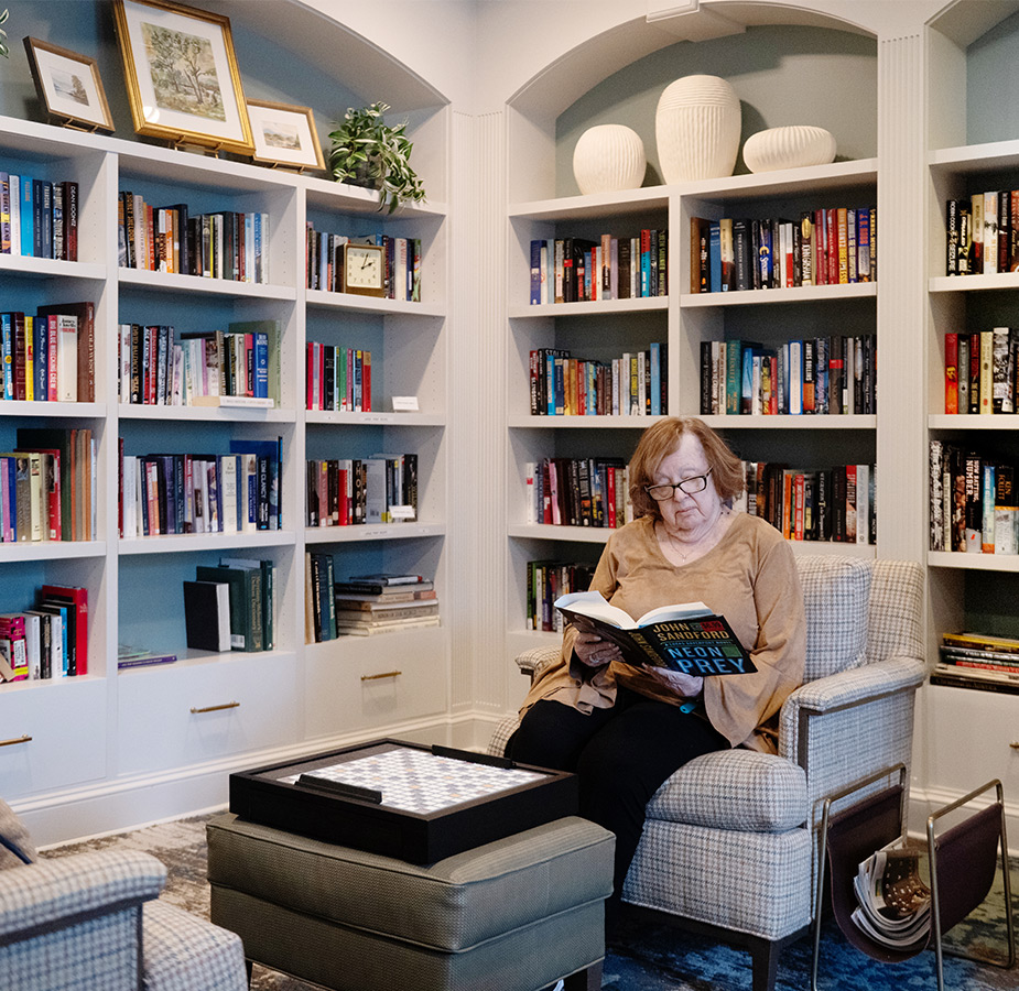 A person sitting in a library reading.
