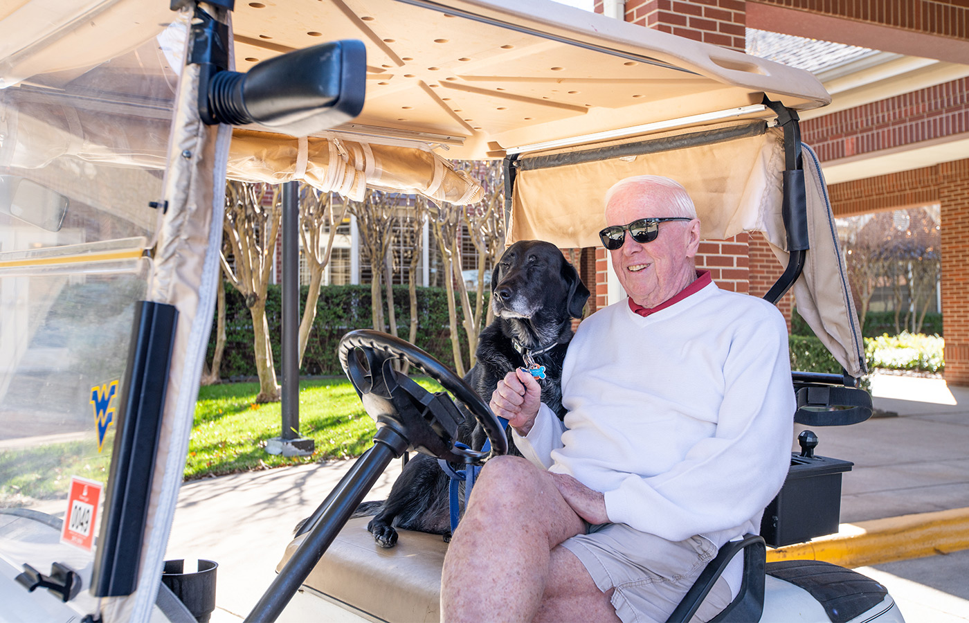A resident in a golf car. A resident in a golf car.