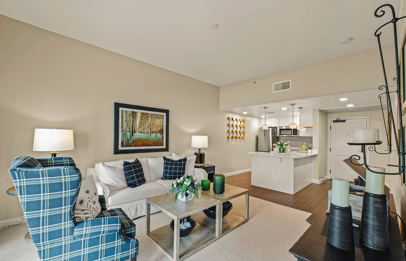 Furnished living room space with sofa, table, and seating area.