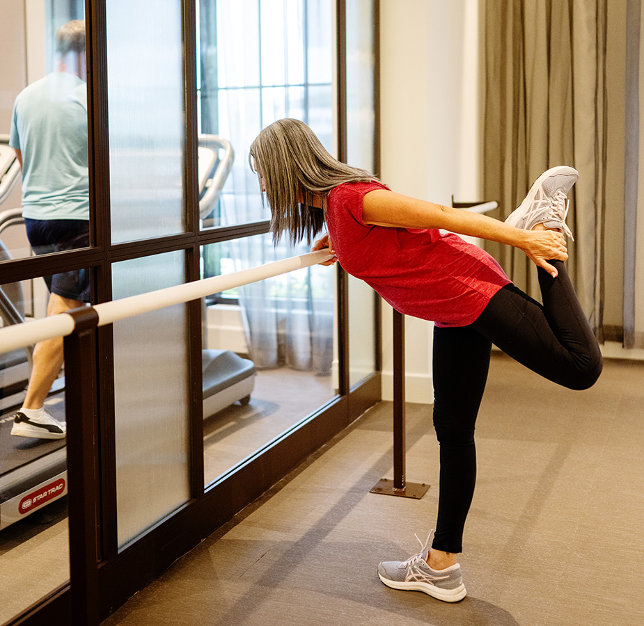 A person stretching at the gym.