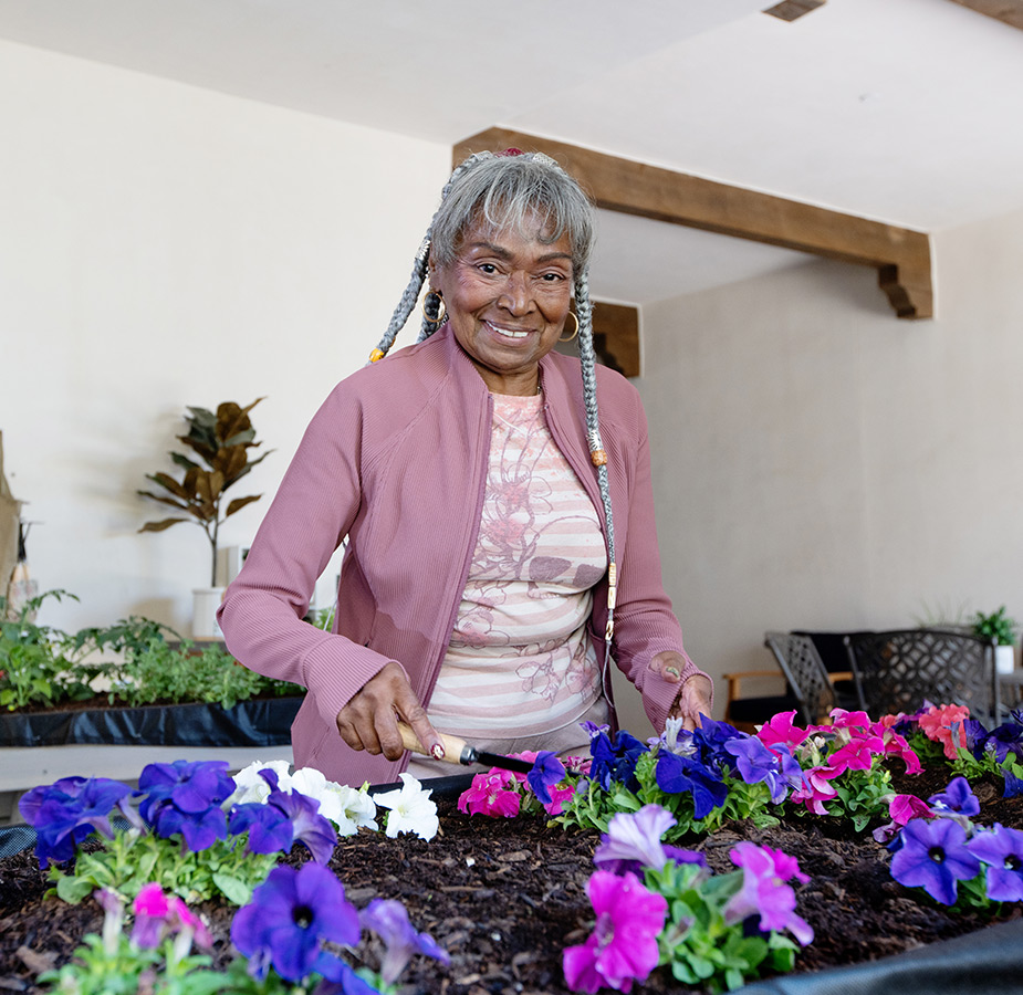 A person at the gardening bench.
