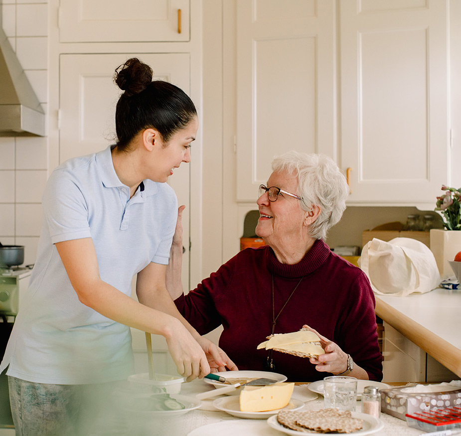 A resident is having lunch with a caregiver.