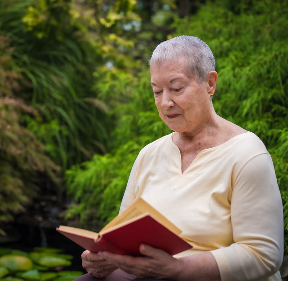 Resident reads book out loud.