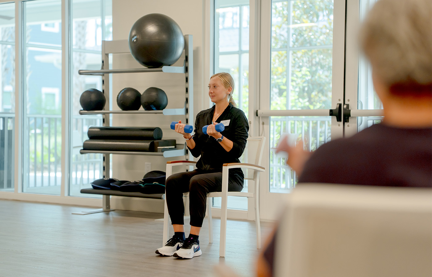 People in a seated fitness class.