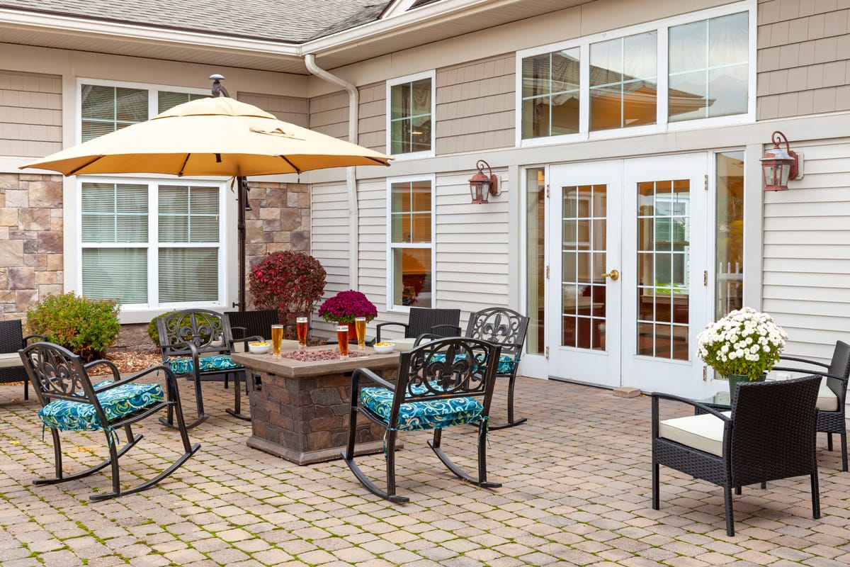 outside patio area with patio furniture covered by an umbrella