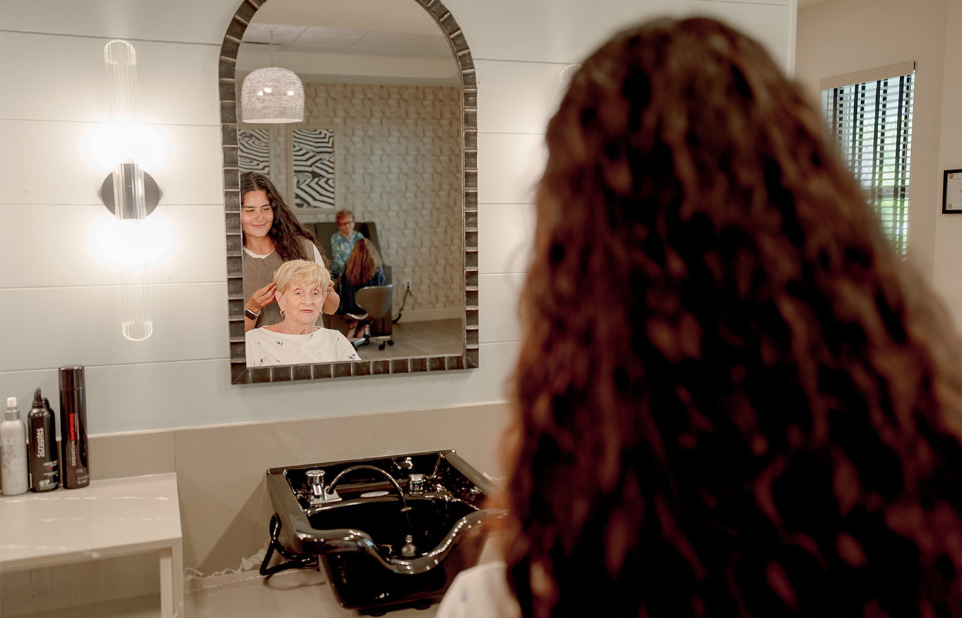 A person getting their hair styled.