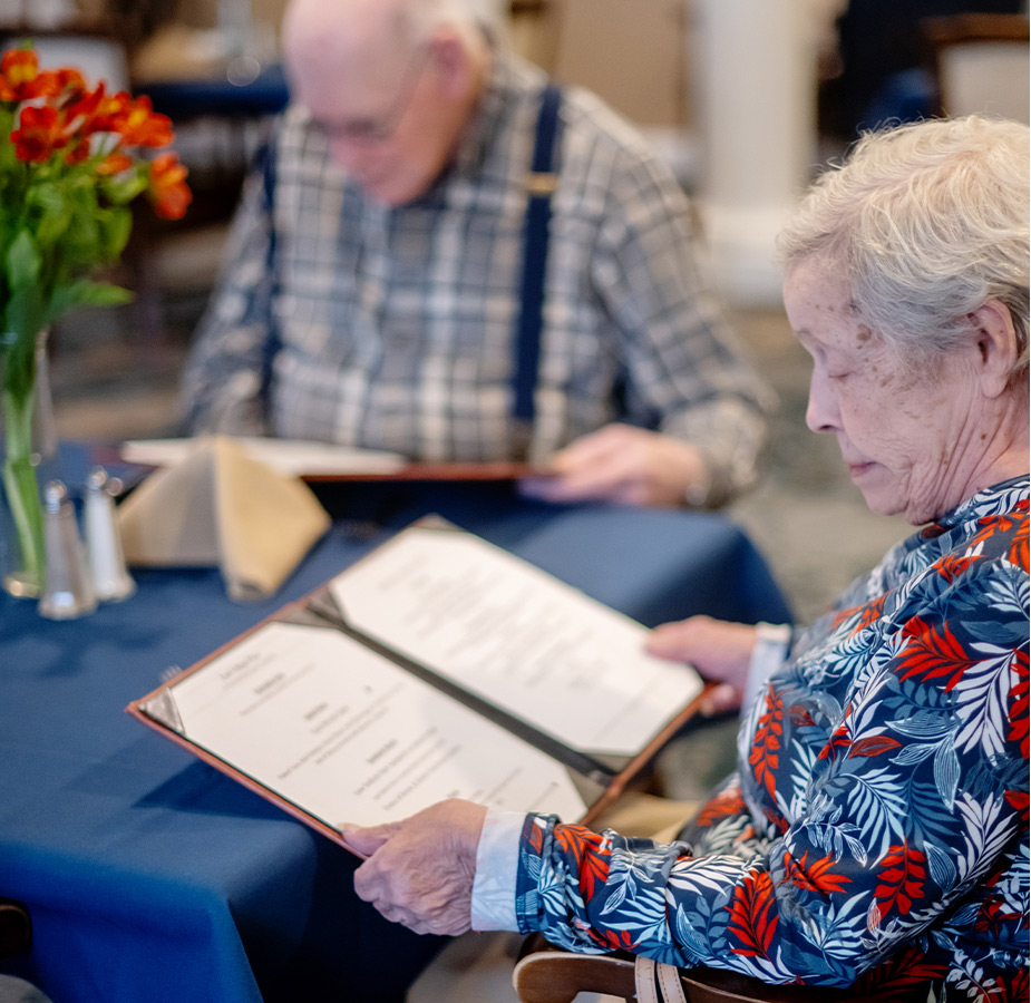 Two people looking at a menu.