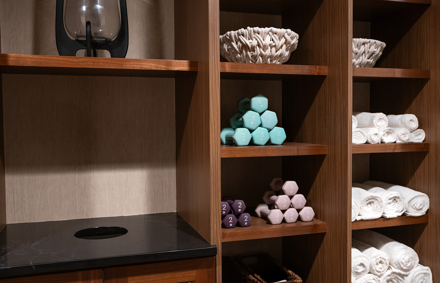 Shelves with weights and towels.