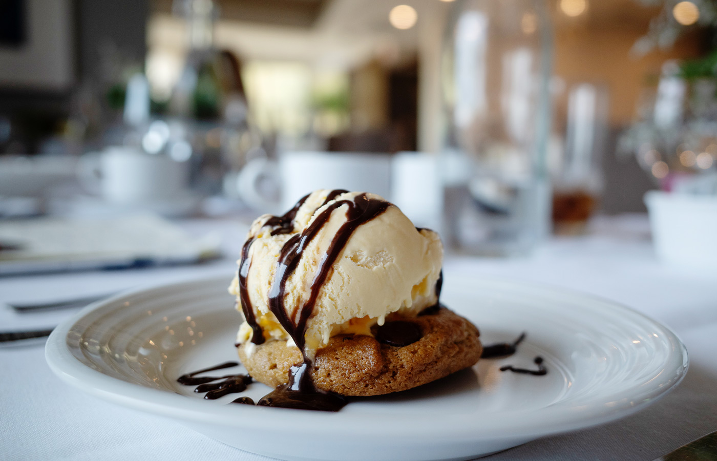 A cookie with ice cream on top.