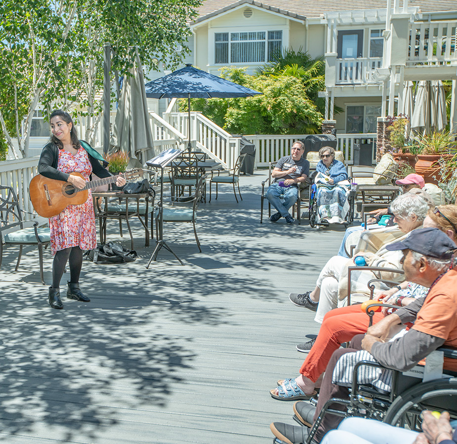 Musician plays guitar for residents.
