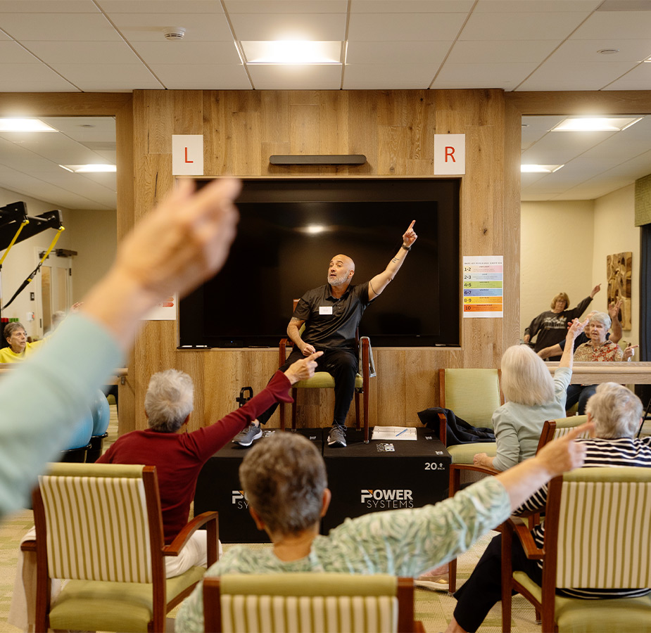 People in a seated fitness class.