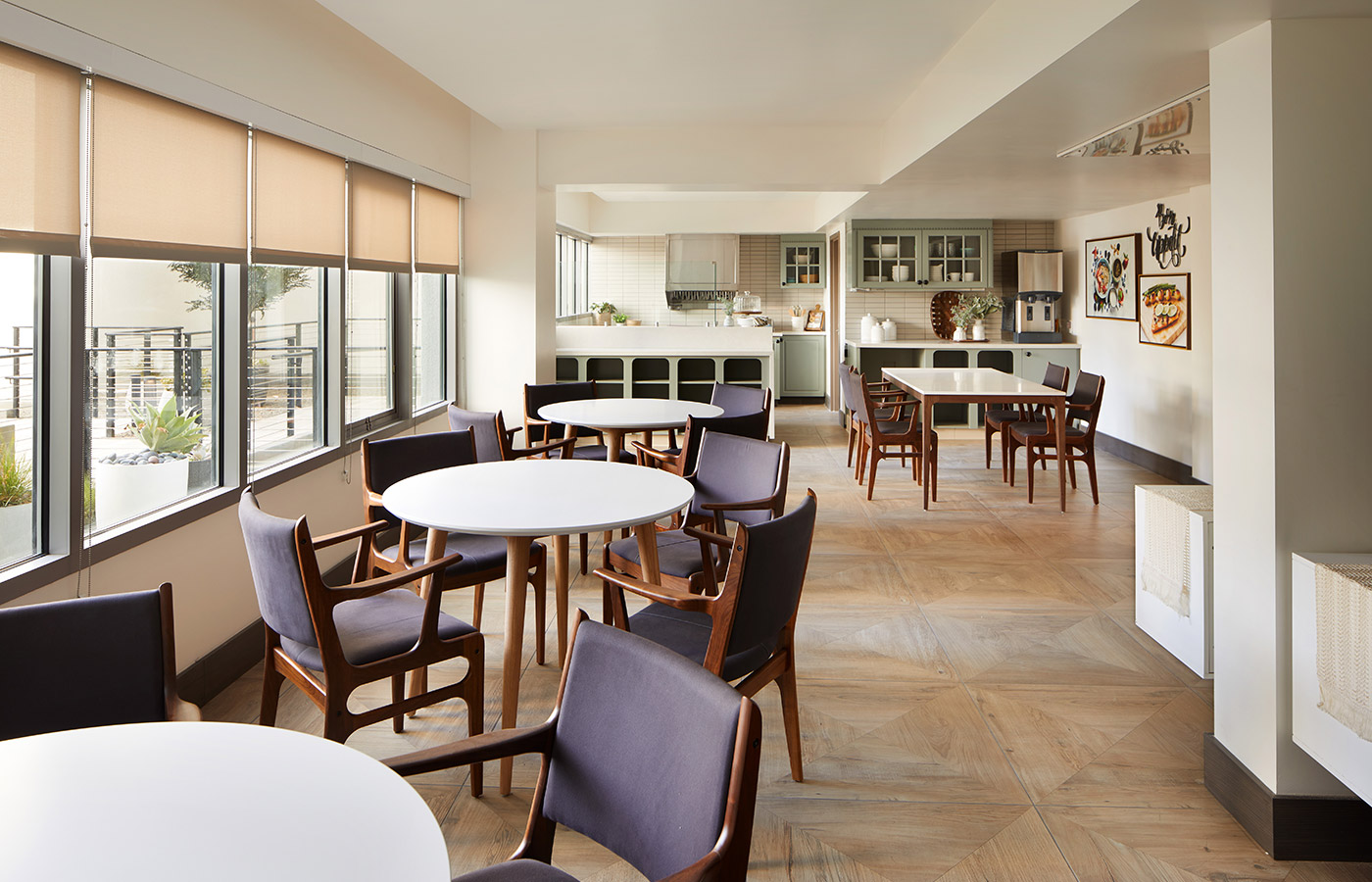 casual dining area with multiple tables and chairs next to large windows
