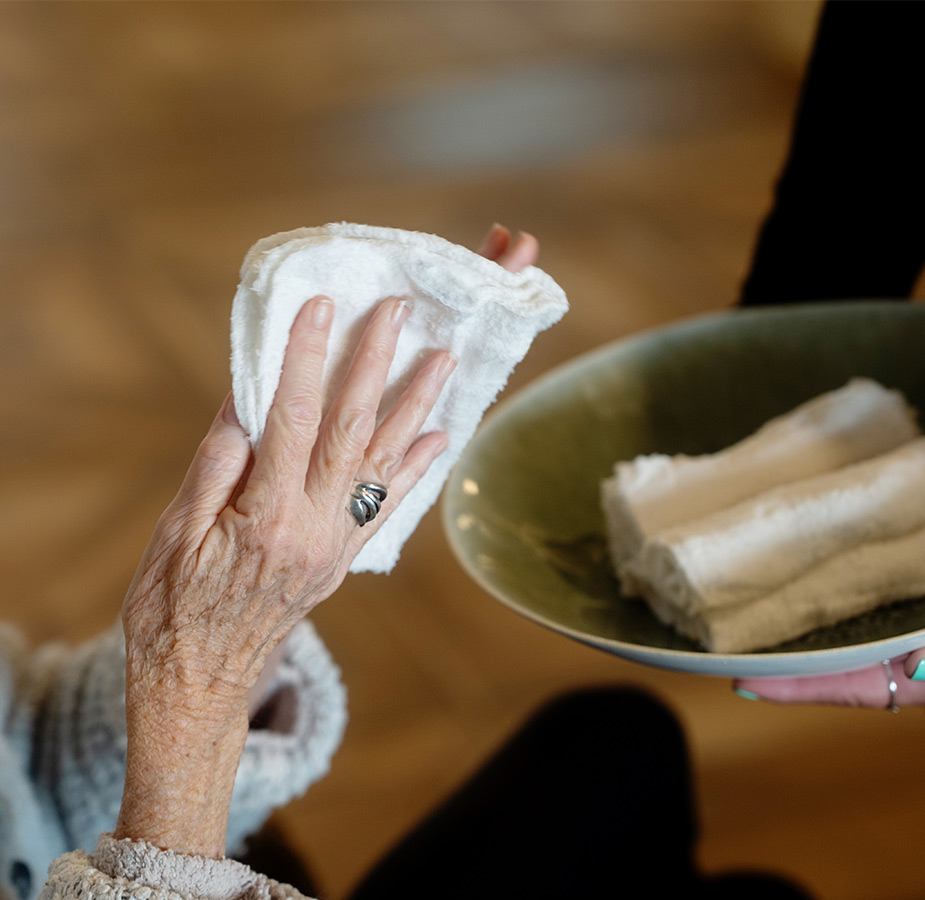 A person wiping their hands with a towel.