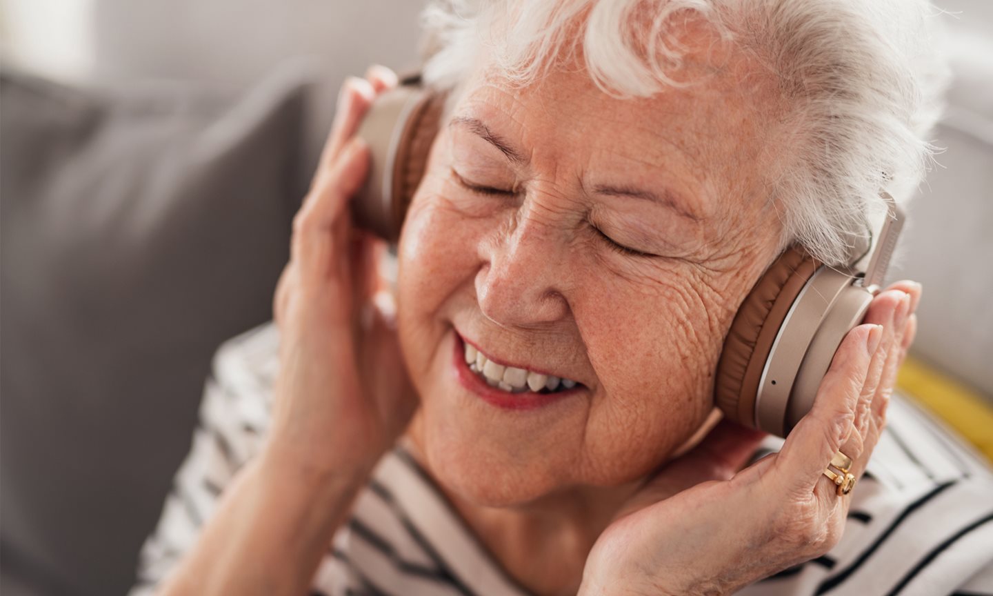 Woman listening to music through headphones.