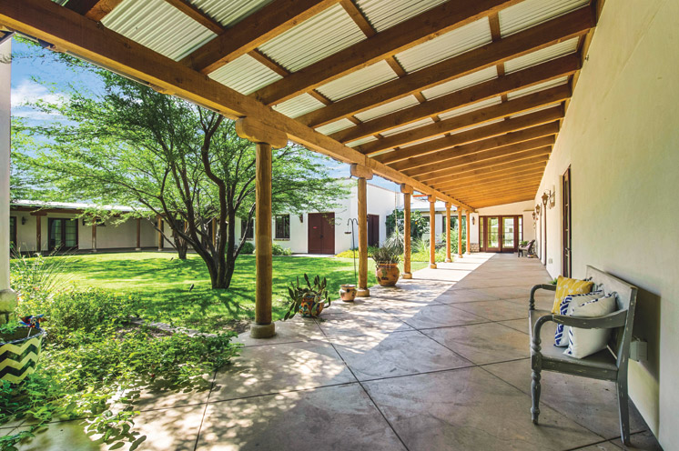 A covered walked way surrounding an outdoor courtyard at The Hacienda at the River.
