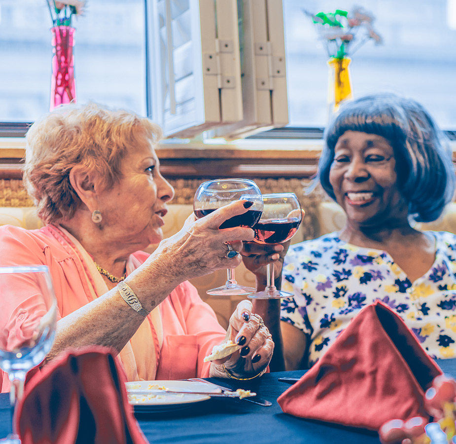 Residents toasting with a glass of wine.