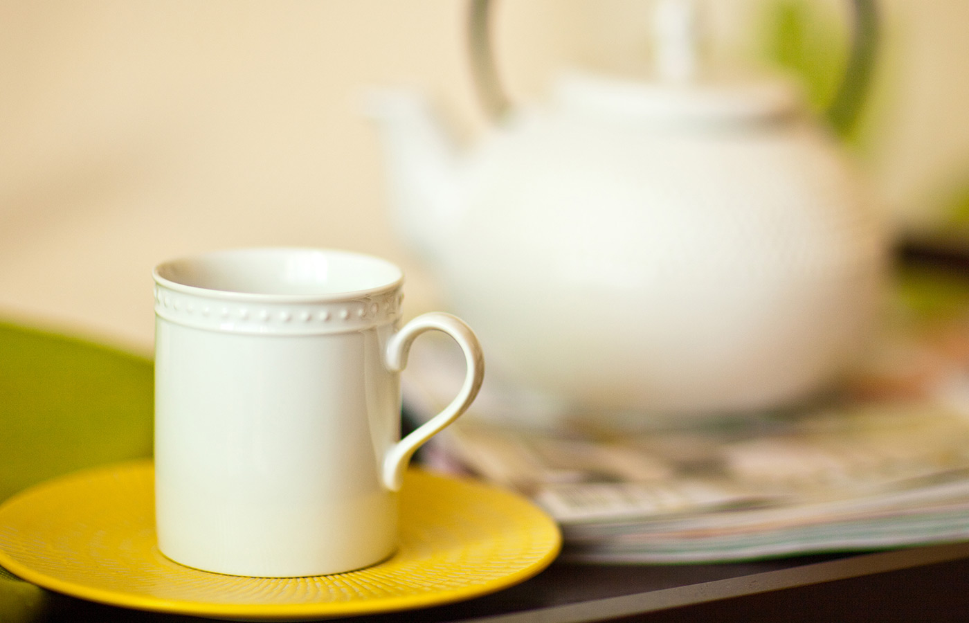 Cup of tea next to pitcher.