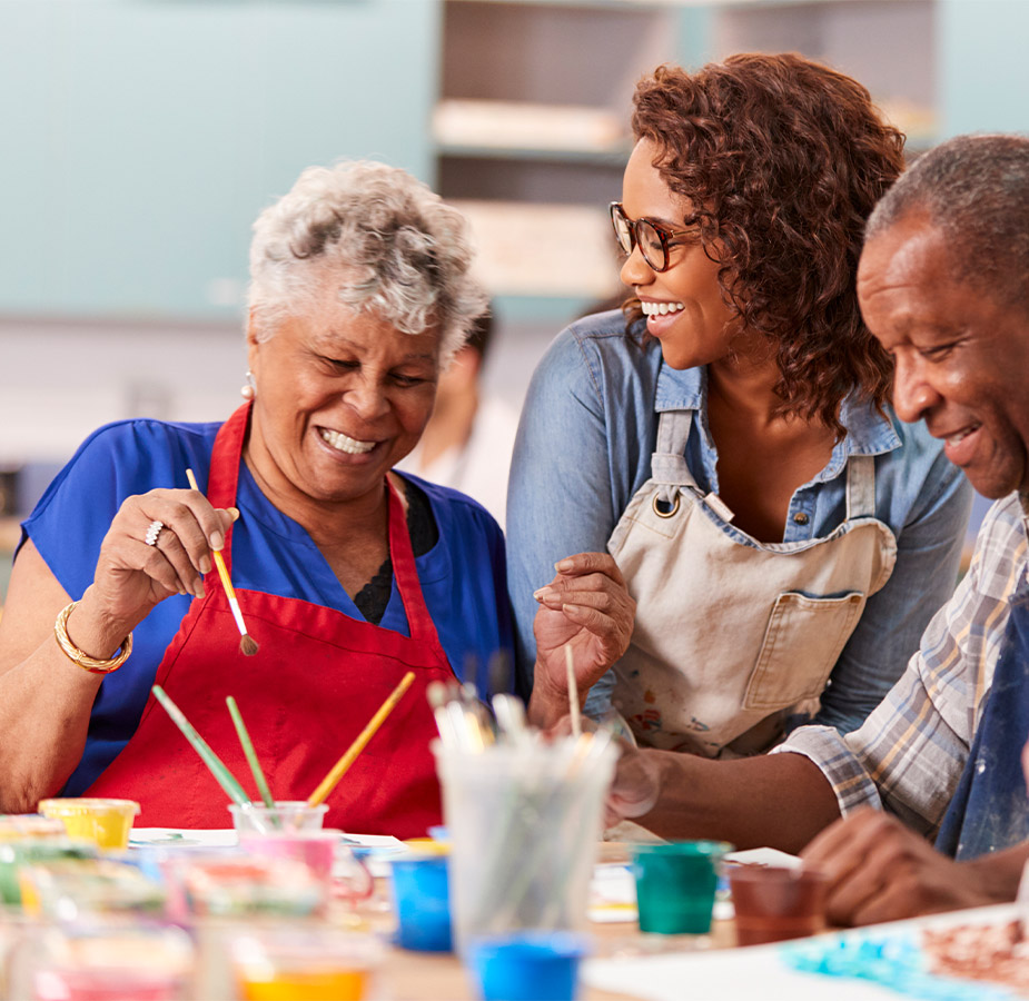 A group of seniors partaking in a painting workshop with an instructor A group of residents partaking in a painting workshop with an instructor.