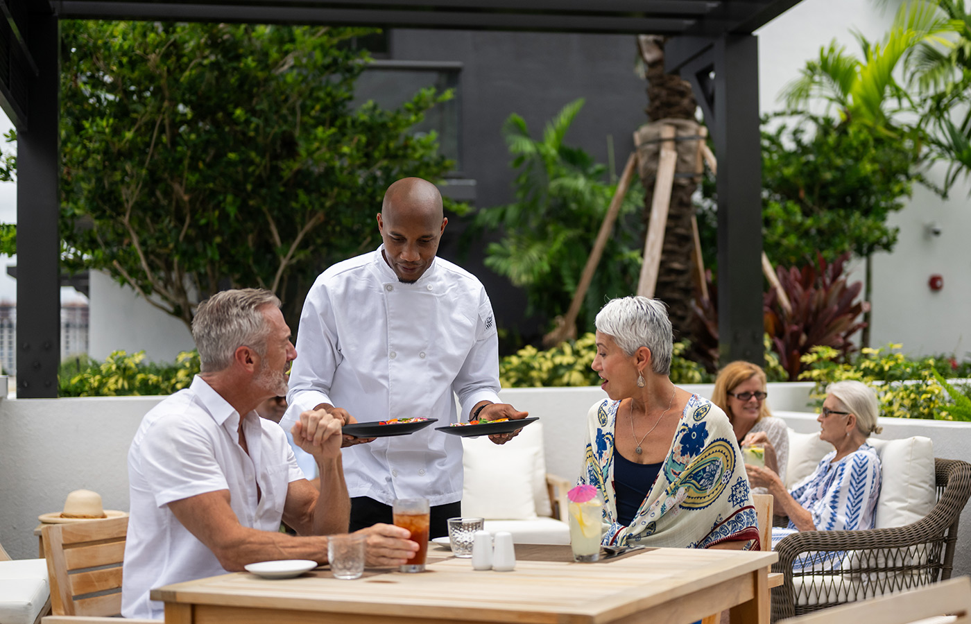 People being served lunch outdoors.