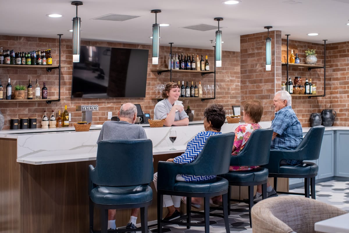 A group of residents having drinks at the bar.