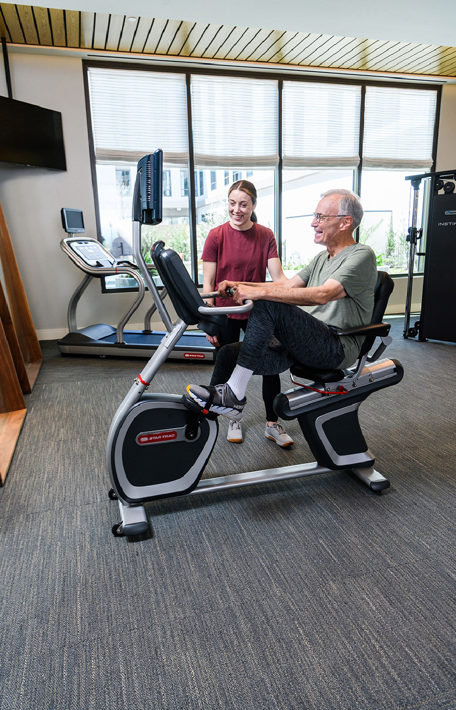 A resident is using a fitness machine.