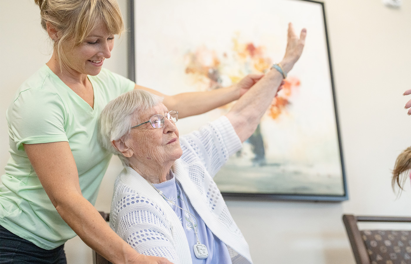 A resident working with a physical therapist.