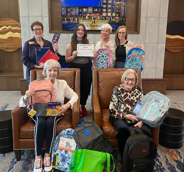 GHG-Back-to-School The Hacienda at Georgetown residents and associates holding up backpacks.