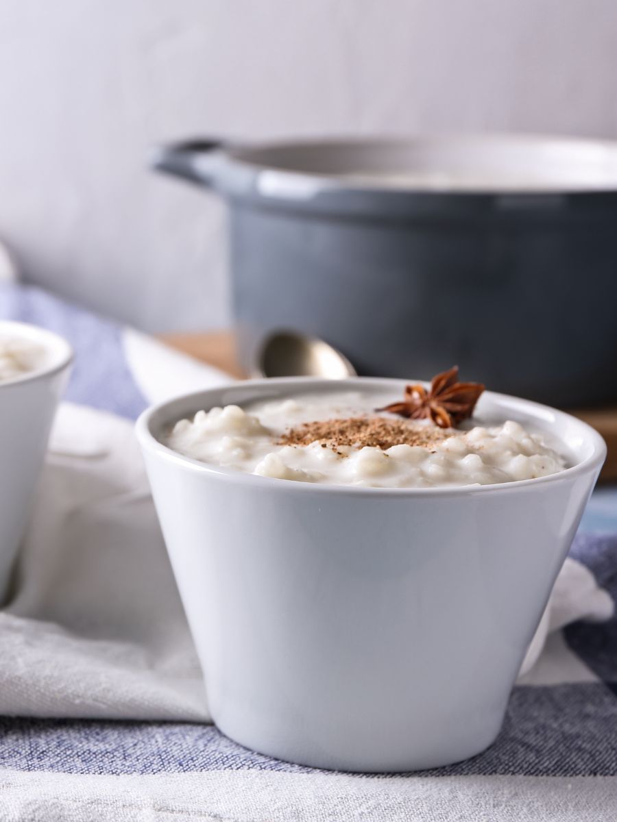 One bowl of rice pudding with a star anise on top.