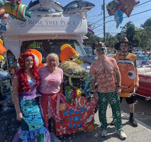 A group of people in a parade with bubbles.