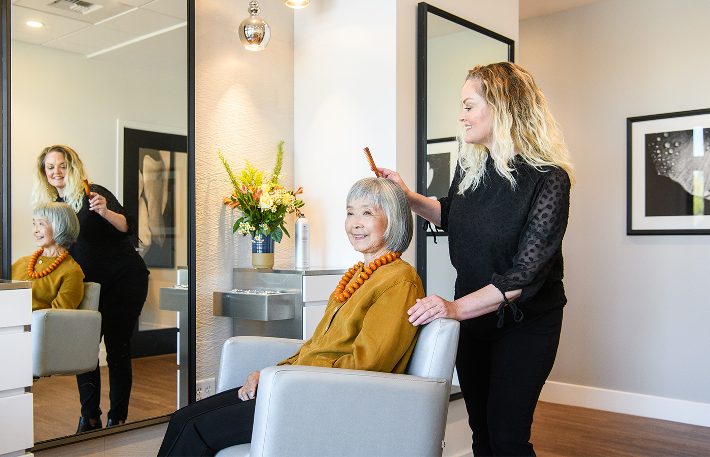 A resident is having their haircut in a salon.