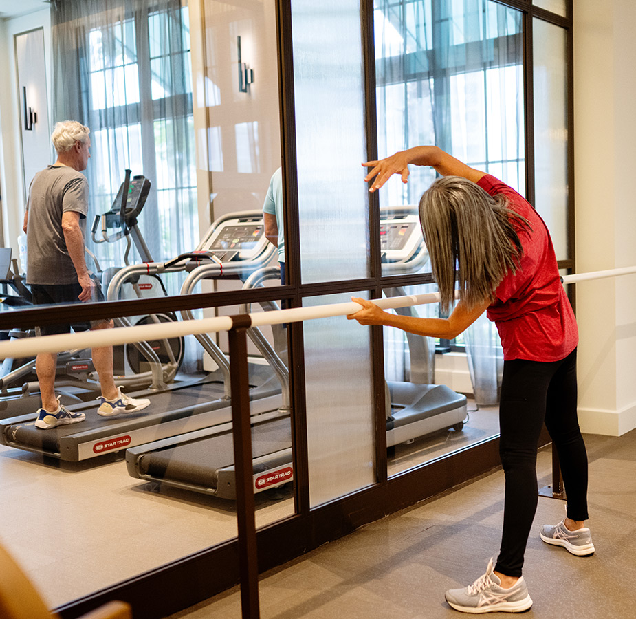 A person stretching at the gym.